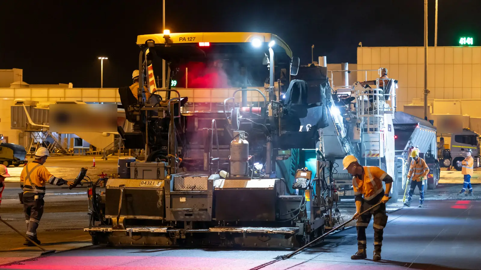 Stock photo: road crew paving an asphalt road at night under bright work lights